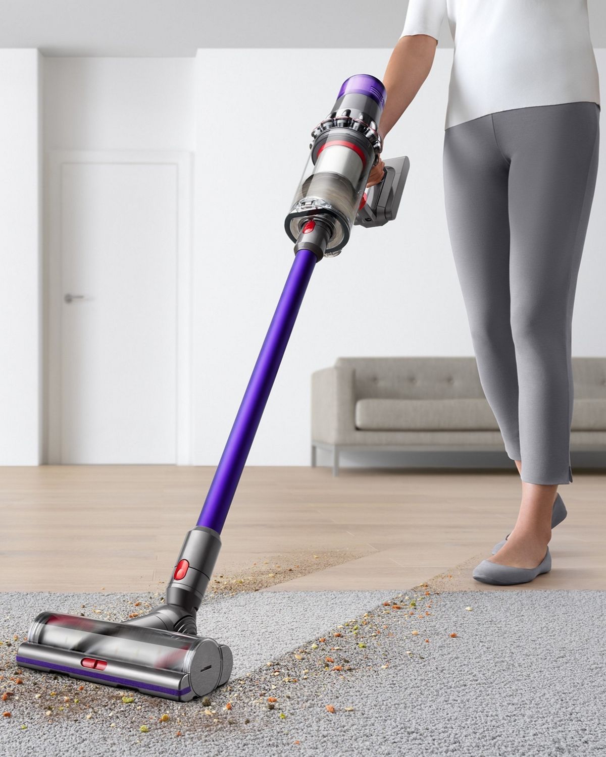 A useDyson V11 Animal cordless vacuum as it picks up debris from hard floor and carpet